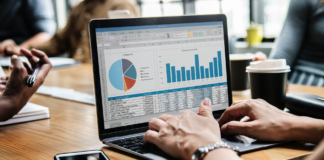 person with laptop on desk doing analytical work