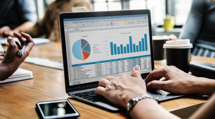 person with laptop on desk doing analytical work