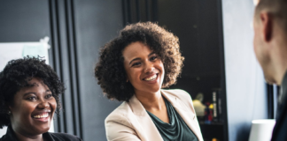 African american woman shaking hands with a man at work