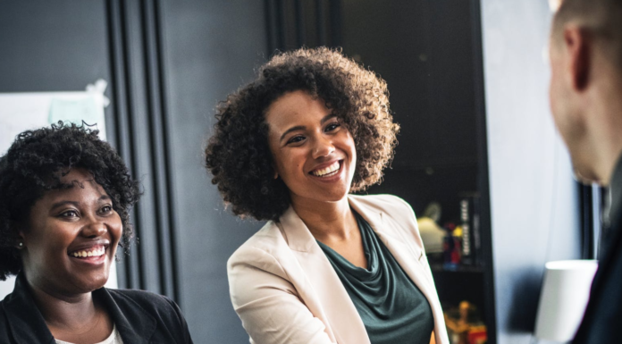 African american woman shaking hands with a man at work