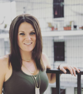 brunette woman smiling and looking into camera 