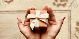 person holding tiny wrapped present