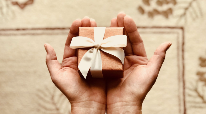 person holding tiny wrapped present