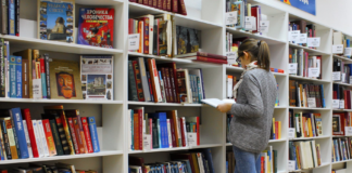 student looking a books in library