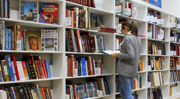 student looking a books in library