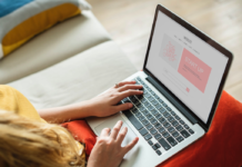 woman with laptop resting on knees doing work