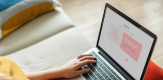 woman with laptop resting on knees doing work