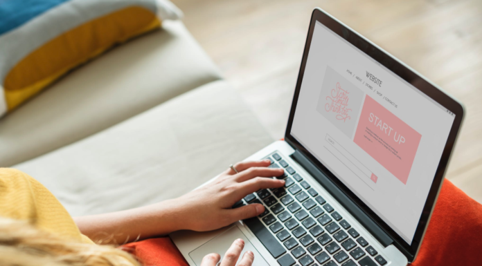 woman with laptop resting on knees doing work